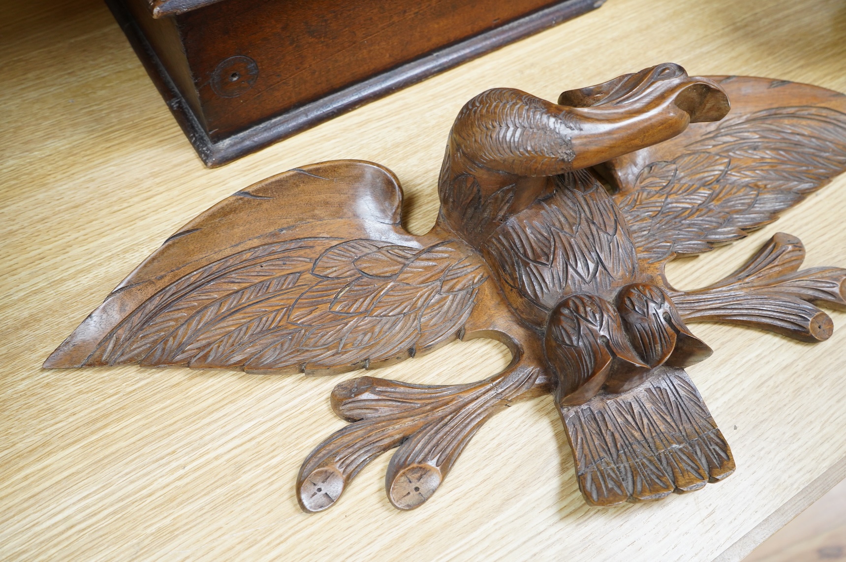 A mahogany leather-handled tool box and carved American eagle wall mount, largest 66cm wide